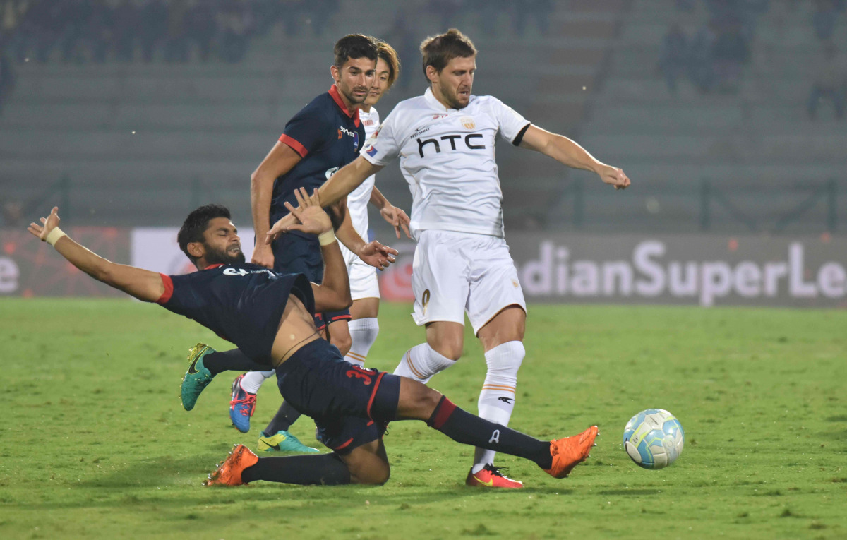 Northeast United FC forward Emiliano Alfaro (R) vies for the ball with Delhi Dynamos FC defender Anas Edathodika during the Indian Super League (ISL) football match between North East United FC and Delhi Dynamos FC at the Indira Gandhi Athletic Stadium in