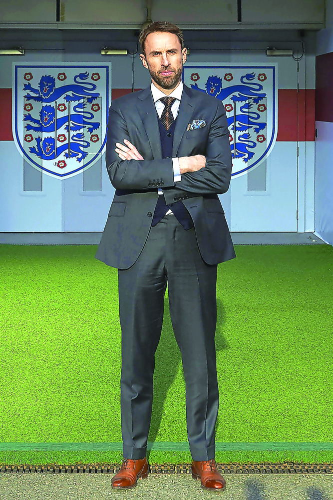 England's new manager Gareth Southgate poses for photographers during a media session after signing a four-year contract with the FA at Wembley Stadium in London, England yesterday.