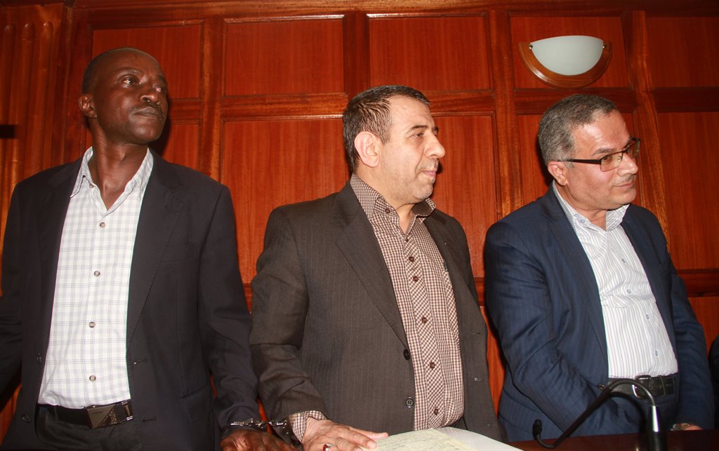 Iranian Nationals Sayed Nasrollah Ebrahimi, Abdolhosein Ghola Safafe and Kenyan driver Moses Keyah Mmboga stand in the dock at the Milimani Law Courts where they were charged for taking video clips of the Israeli embassy in Kenya's capital Nairobi, Decemb