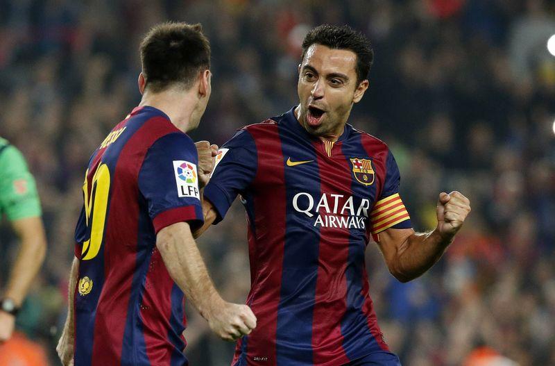 File photo of Lionel Messi (L) with teammate Xavi Hernandez during a match in Barcelona. Reuters 