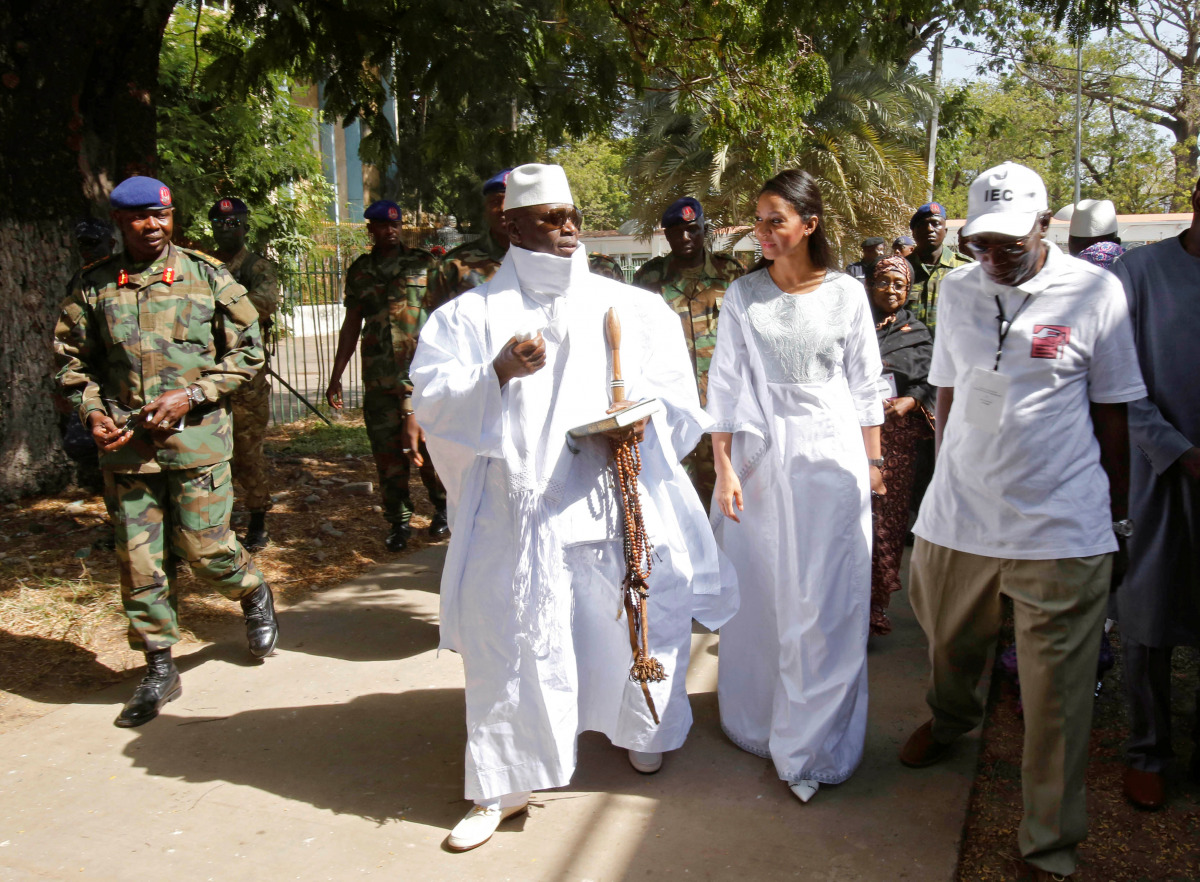 Gambian President Yahya Jammeh leaves a polling station with his wife Zineb during the presidential election in Banjul, Gambia, December 1, 2016. (Reuters/Thierry Gouegnon)