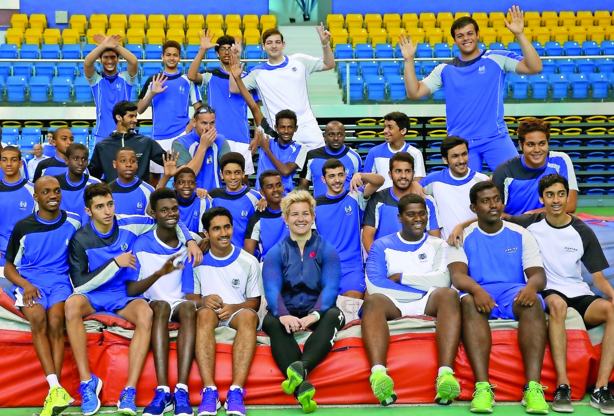 Polish Olympic  champion, dubbed as the ‘greatest female hammer thrower’ of  all time, Anita  Wlodarczyk (centre) poses for a photograph with student-athletes  of Aspire  Academy in Doha. Wlodarczyk arrived in Doha to take part  in a three-week training c