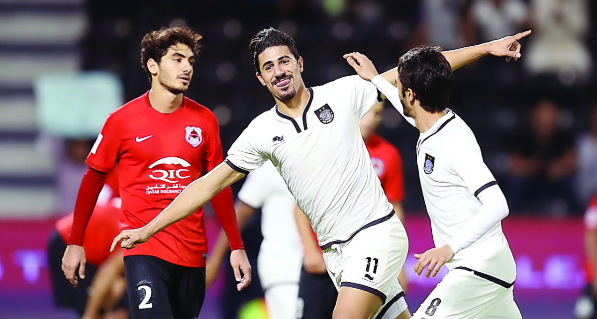 Al Sadd's Bagdad Bounedjah  (centre) celebrates after scoring one of his three goals during yesterday's El Clasico against Al Rayyan at Jassim Bin Hamad Stadium.  