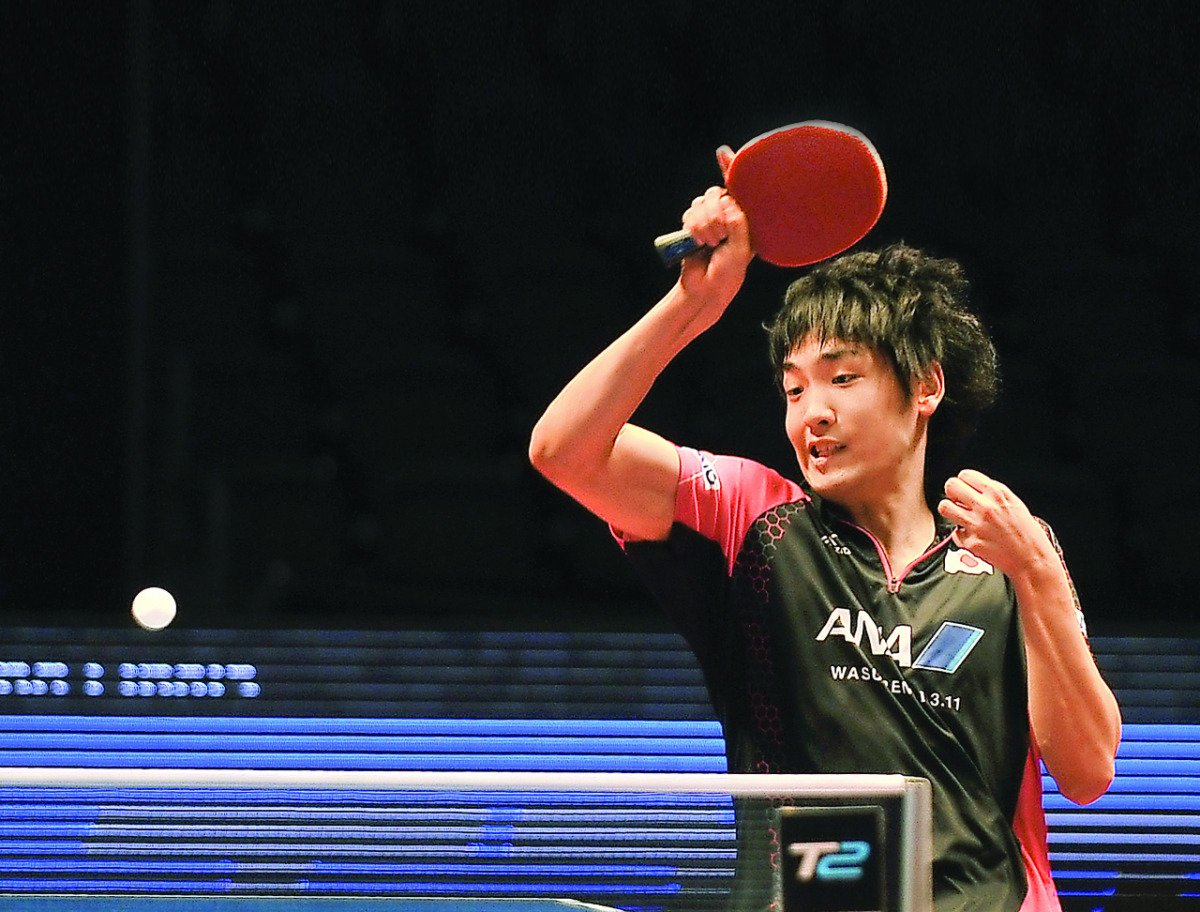 Japan's Yuto Muramatsu returns the ball to Vladimir Samsonov of Belarus, during their Men's singles pre-quarter-final game of the Seamaster ITTF World Tour Finals at the Ali Bin Hamad Al Attiyah Arena in Doha yesterday. Muramatsu shocked the European gian