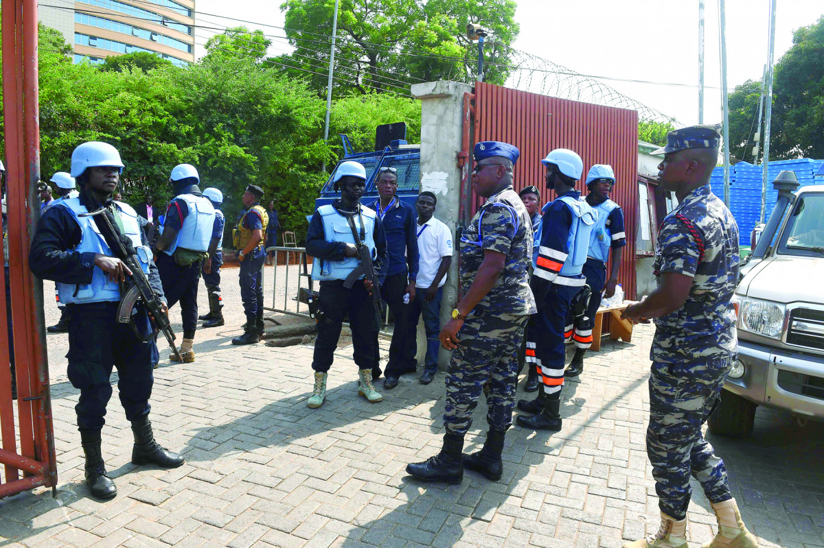 Anti-riot policemen led by Divisional Superintendent of Police Kumashie Freeman (centre) stand at the main gate that leads to the headquarters of the Electoral Commission, in Accra, yesterday.