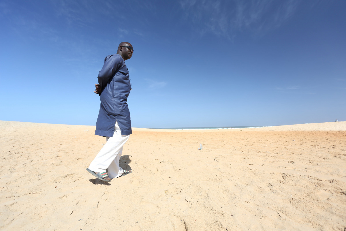 Gambian national Ebrima Sanneh, who has been in exile since 2013, walks on a beach in Dakar, Senegal, December 5, 2016. REUTERS/Mikal McAllister