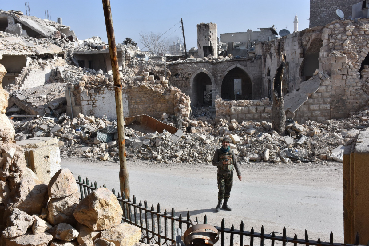 A member of the Syrian pro-government forces patrols Aleppo's Bab al-Nairab neighbourhood on December 10, 2016. Syria's government has retaken at least 85 percent of east Aleppo, which fell to rebels in 2012, since beginning its operation on November 15. 