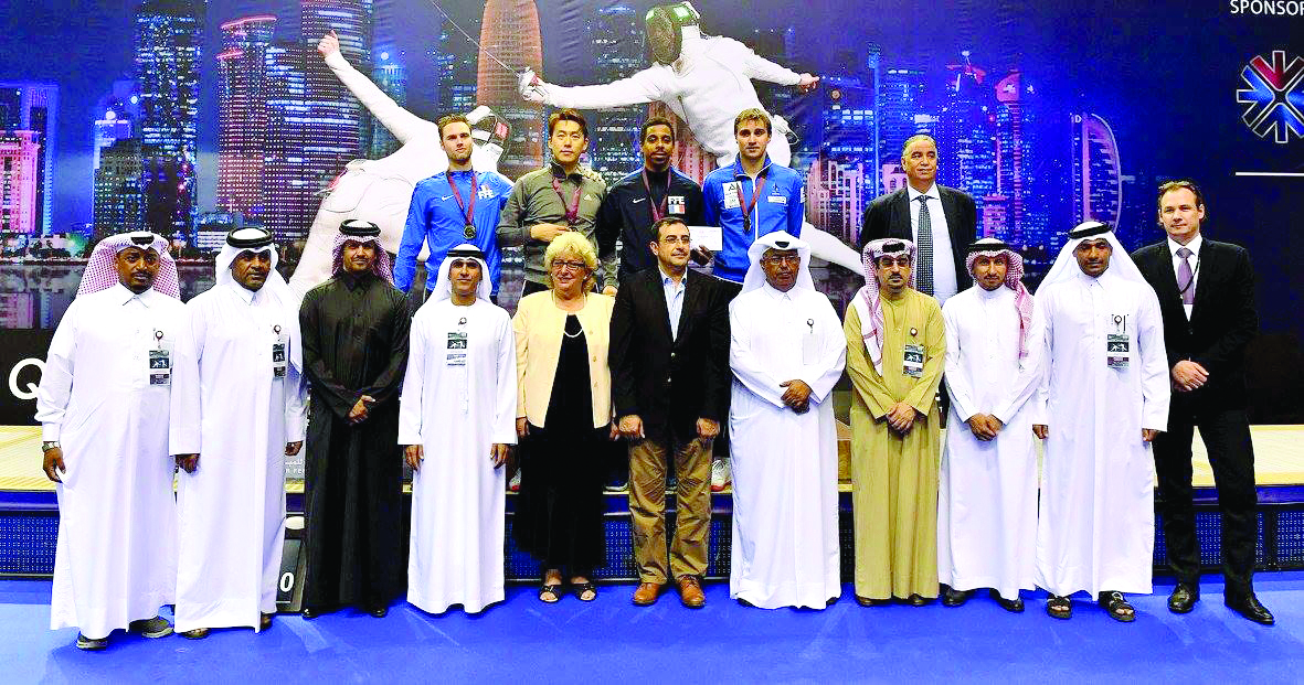 Youngjun Kweon of Korea, winner of the Qatar Grand Prix poses for a group picture with officials of Qatar Fencing Federation at Aspire Zone yesterday. Kweon defeated Bardenet Alexandreof France 15-13 in the final. In the semi-final, Kweon defeated Nikolai