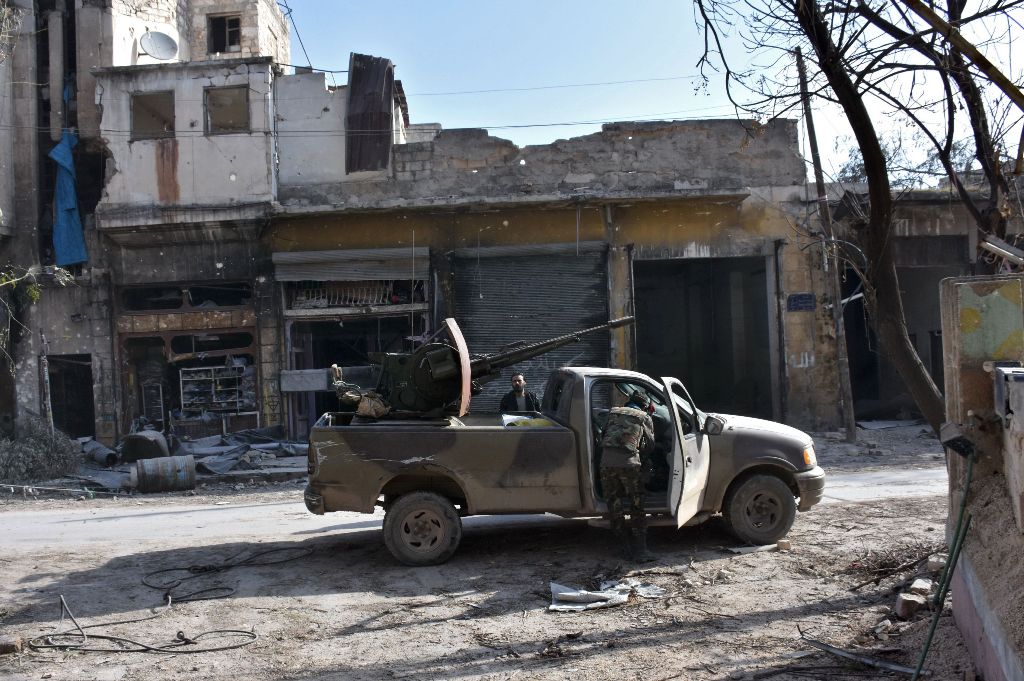 Syrian pro-government forces patrol Aleppo's Bab al-Nairab neighbourhood on December 10, 2016. Syria's government has retaken at least 85 percent of east Aleppo, which fell to rebels in 2012, since beginning its operation on November 15. / AFP / George OU