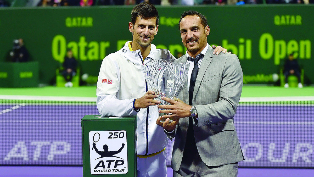 The defending champion and world number two Novak Djokovic (left) of Serbia receives the 2017 QatarExxon Mobil Open award from  Tournament Director Karim Alami in this file photo.