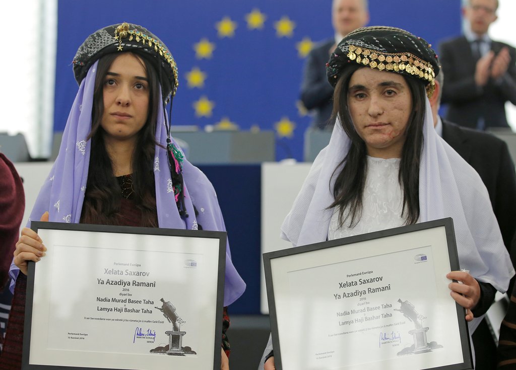 Nadia Murad Basee Taha (L) and Lamiya Aji Bashar, both Iraqi women of the Yazidi faith, pose with the 2016 Sakharov Prize during an award ceremony at the European Parliament in Strasbourg, France, December 13, 2016. REUTERS/Vincent Kessler
