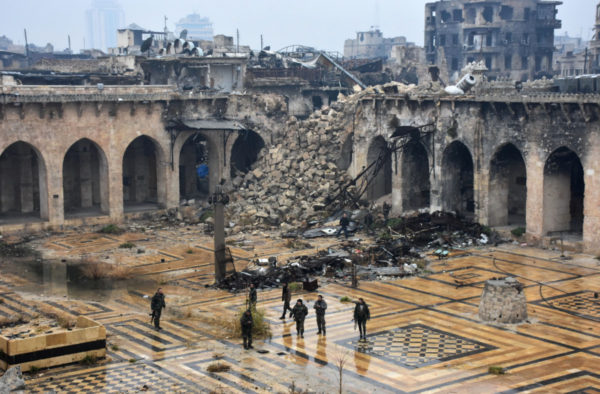  A general view shows Syrian pro-government forces walking in the ancient Umayyad mosque in the old city of Aleppo on December 13, 2016, after they captured the area. After weeks of heavy fighting, regime forces were poised to take full control of Aleppo,