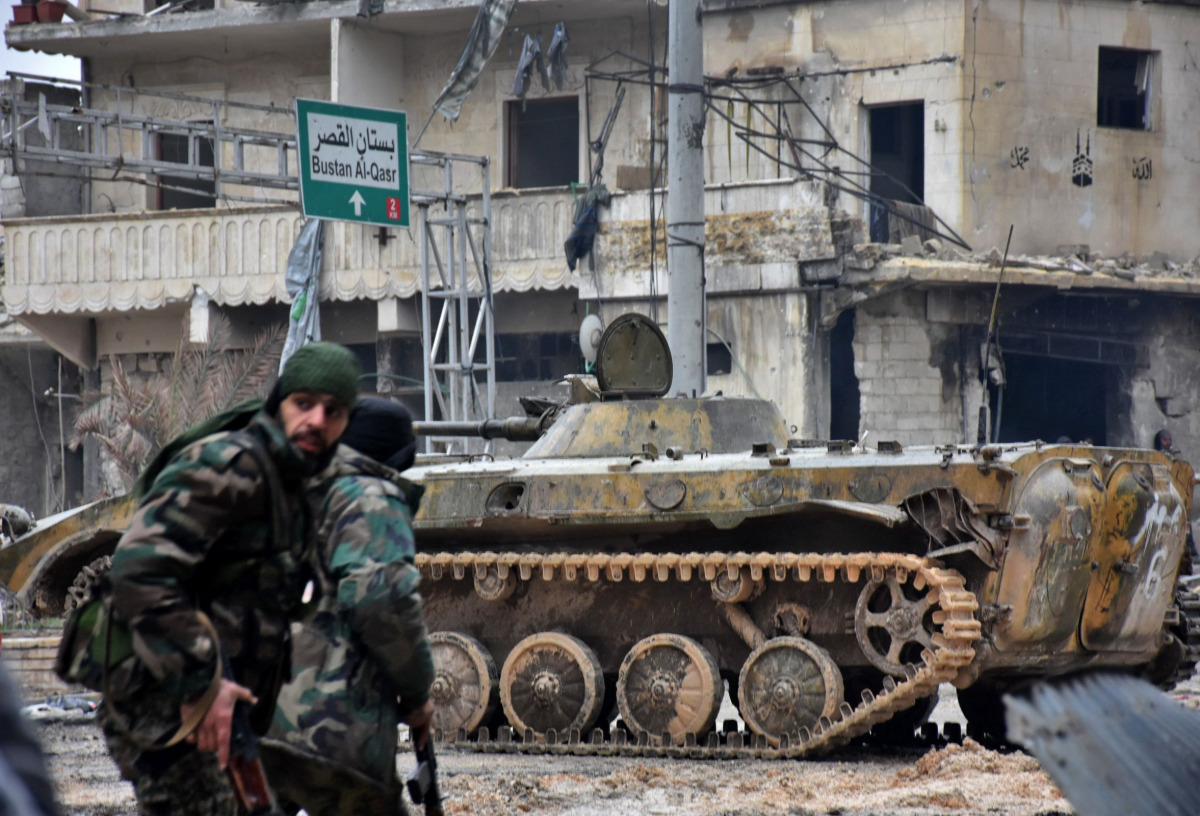 Syrian pro-government forces patrol the northern embattled city of Aleppo on December 14, 2016. Shelling and air strikes sent terrified residents running through the streets of Aleppo as a deal to evacuate rebel districts of the city was in danger of fall
