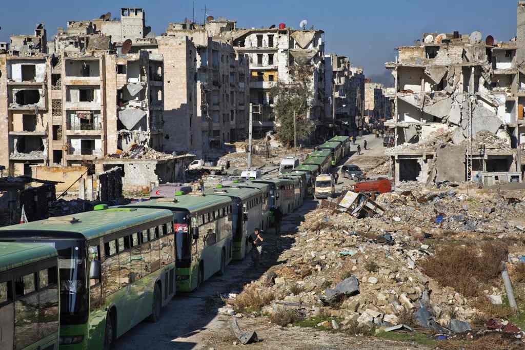 Buses are seen during an evacuation operation of rebel fighters and their families from rebel-held neighbourhoods in the embattled city of Aleppo on December 15, 2016. A convoy of ambulances and buses left rebel territory in Aleppo in the first evacuation
