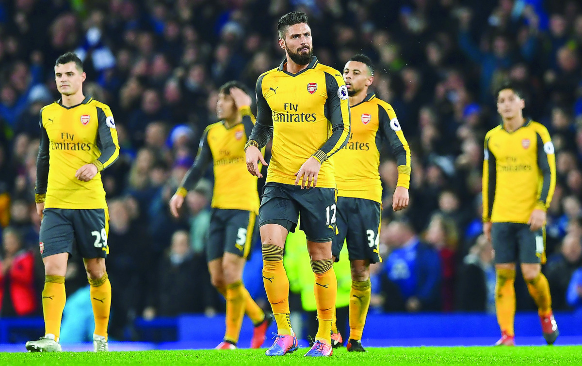 Arsenal's Olivier Giroud (centre) and team-mates react after Everton's Ashley Williams scored his teams's second goal during their Premier League match at Goodison Park Stadium in Liverpool, England on Tuesday.