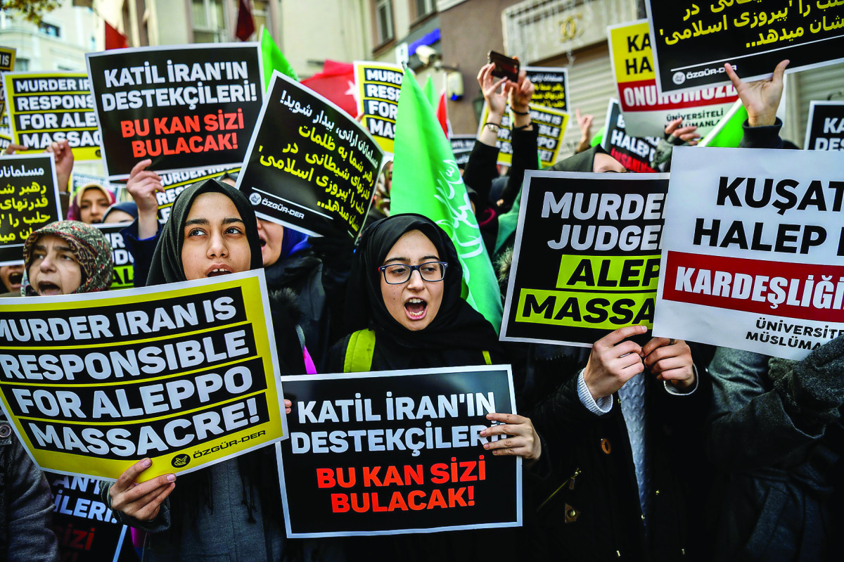 Protesters shout anti-Iran slogans and hold placards in front of the Iranian embassy in Istanbul yesterday, against Iranian involvement in the siege of Aleppo. 