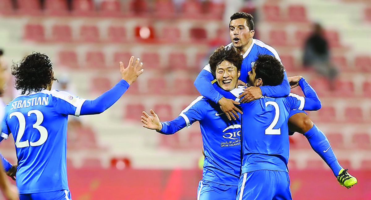 Al Rayyan's Sebastian Soria (left) and Mohammed Alaeddin Abdalmtaal celbrate the goal scored by Koh Myong Jin (centre) against duringtheir Qatar Stars League match at At Grand Hamad Stadium in Doha, yesterday.