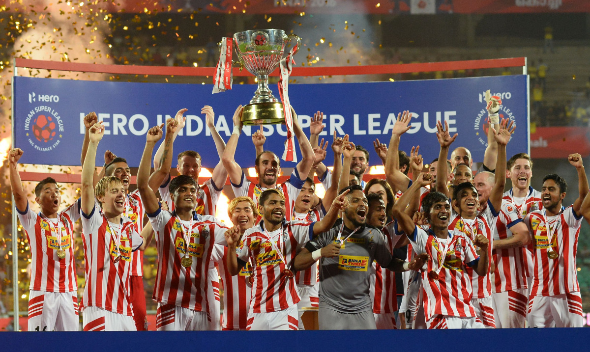 Atletico de Kolkata players celebrate with the trophy after winning the Indian Super League (ISL) final football match against Kerala Blasters FC at the Jawahar Lal Nehru Stadium in Kochi on December 18, 2016. (AFP / SAJJAD HUSSAIN)
