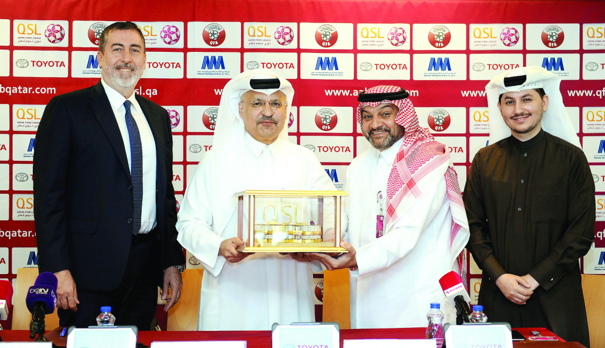 CEO of QSL, Hani Taleb Ballan (second right), presenting a memento to AAB Toyota Chairman, Osama Abdullah Abdulghani, as AAB Toyota CEO, Serdar Toktamis (left), and QSL Executive Director for Marketing and Communications, Khalifa Saleh Al Haroon (right) s