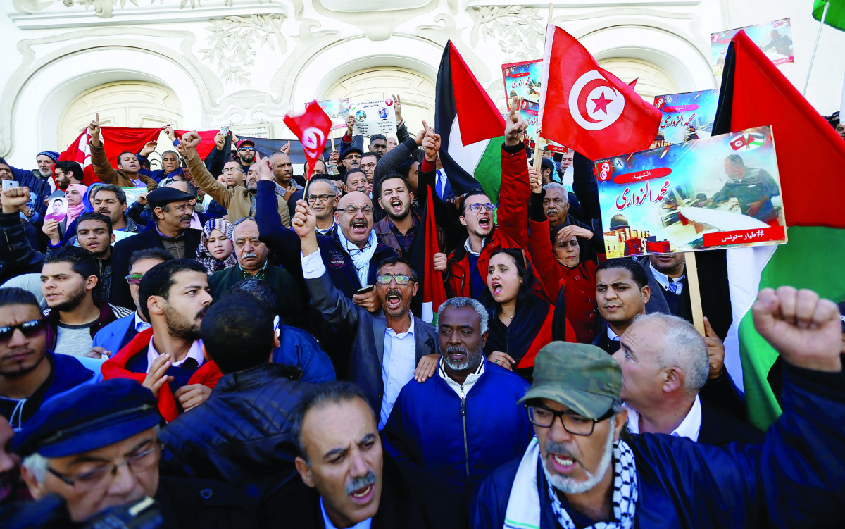 Tunisians gather in front of the Municipal Theatre during a protest against the assassination last week of Tunisian national Mohammed Zawari, who Palestinian Hamas group said was one of its drone experts, in Tunis, Tunisia December 20, 2016. REUTERS/Zoube