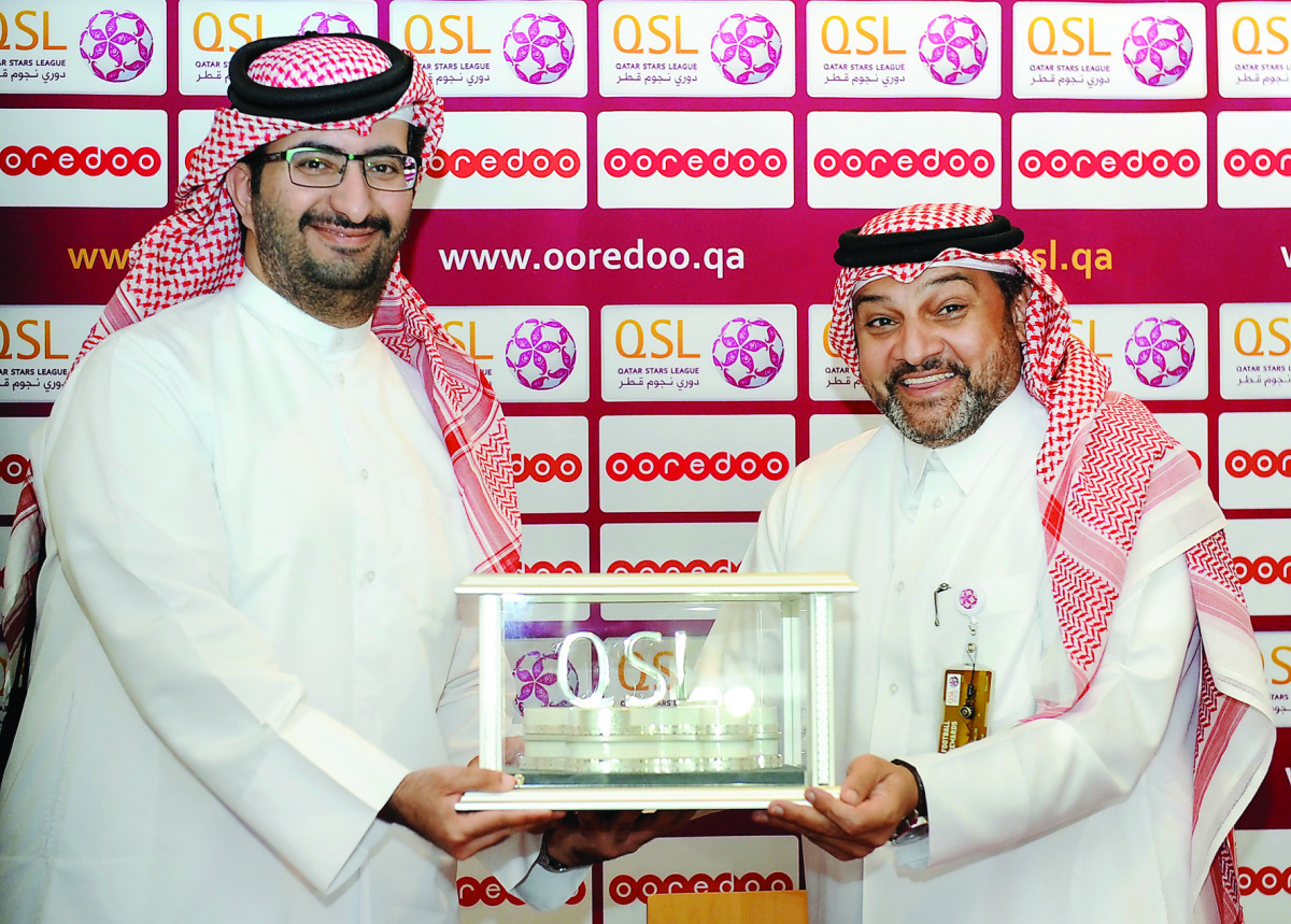 Sheikh Ali bin Jabor Al Thani, CLRO, Ooredoo Qatar, and Hani Ballan, Chief Executive Officer, Qatar Stars League, exchanging documents after signing the agreement.