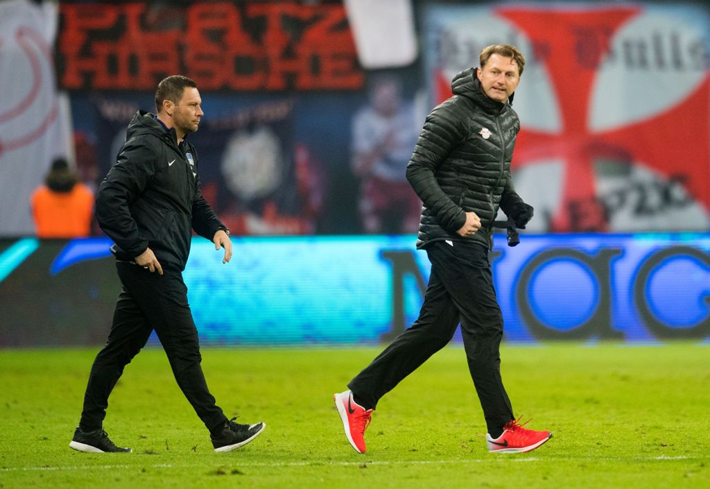 Leipzig's Austrian head coach Ralph Hasenhuettl (R) celebrates next to Herth's Hungarian head coach Pal Dardai after winning during the German first division Bundesliga football match between RB Leipzig and Hertha BSC Berlin in Leipzig, eastern Germany on