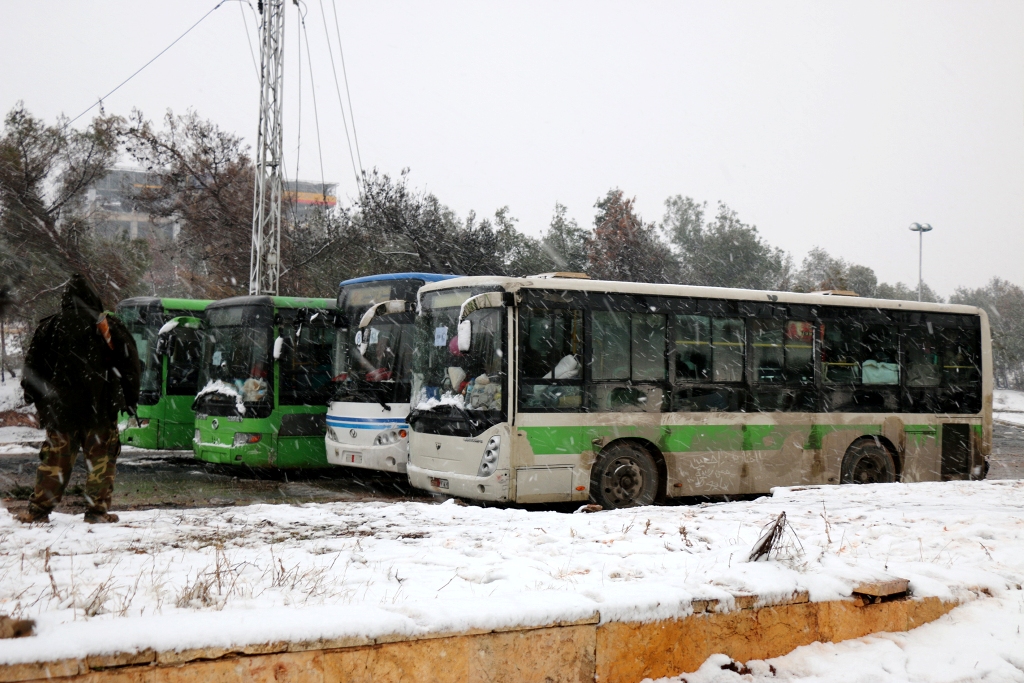 ALEPPO, SYRIA - DECEMBER 21: A convoy, evacuating civilians who flee from Assad regime supporter foreign terrorists controlled Fua and Kefraya towns those had been under siege by opposition groups, move forward Assad regime controlled western rural parts 
