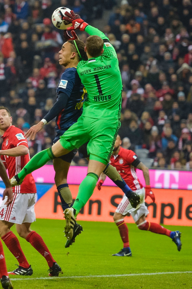 Leipzig's Yussuf Poulsen (left) and Bayern Munich's goalkeeper Manuel Neuer vie for the ball possession during their Bundesliga match at Allianz Arena in Munich, Germany, on Wednesday. 