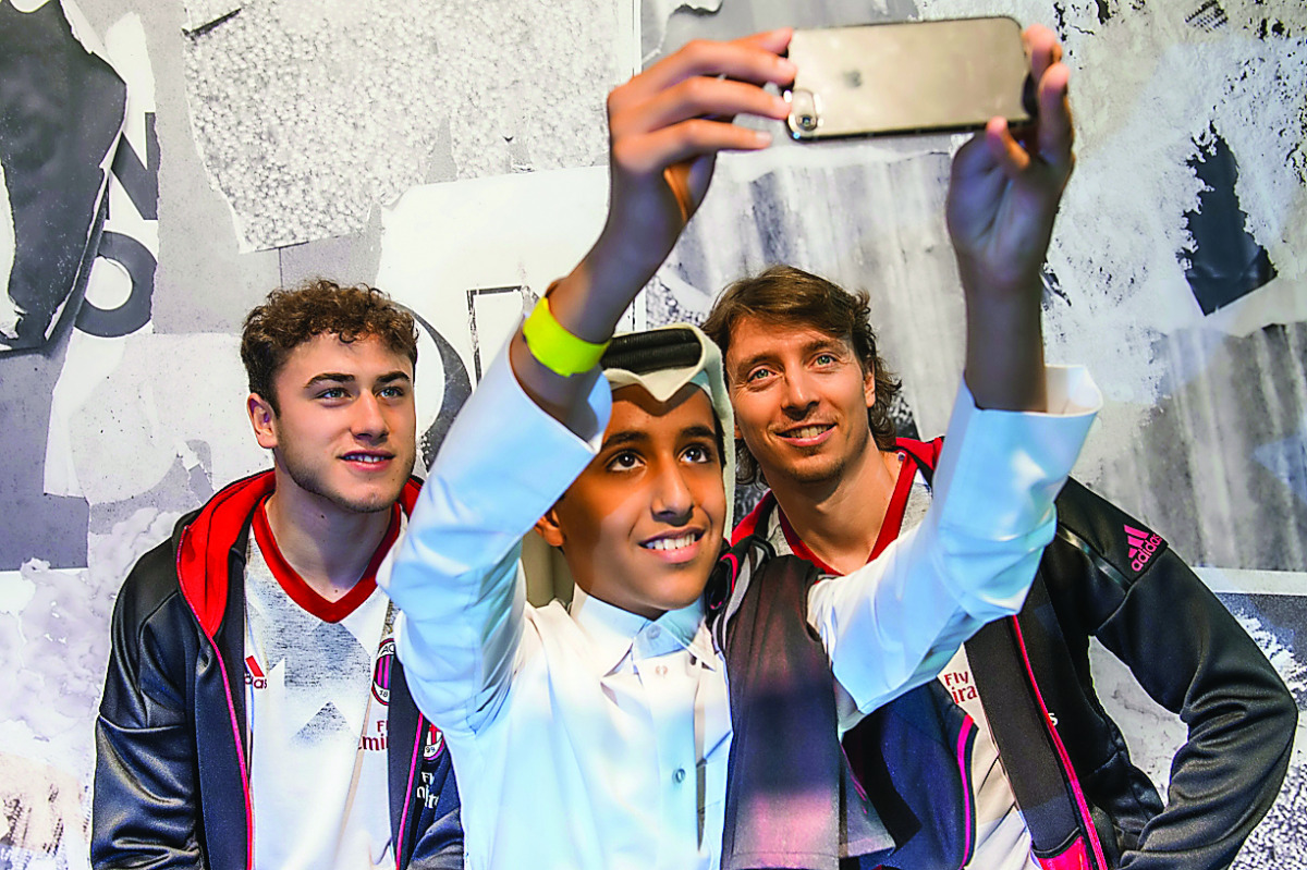 A Qatari football fan takes a selfie with AC Milan players Montolivo and Calabria during their visit to the adidas store at Villaggio Mall yesterday.