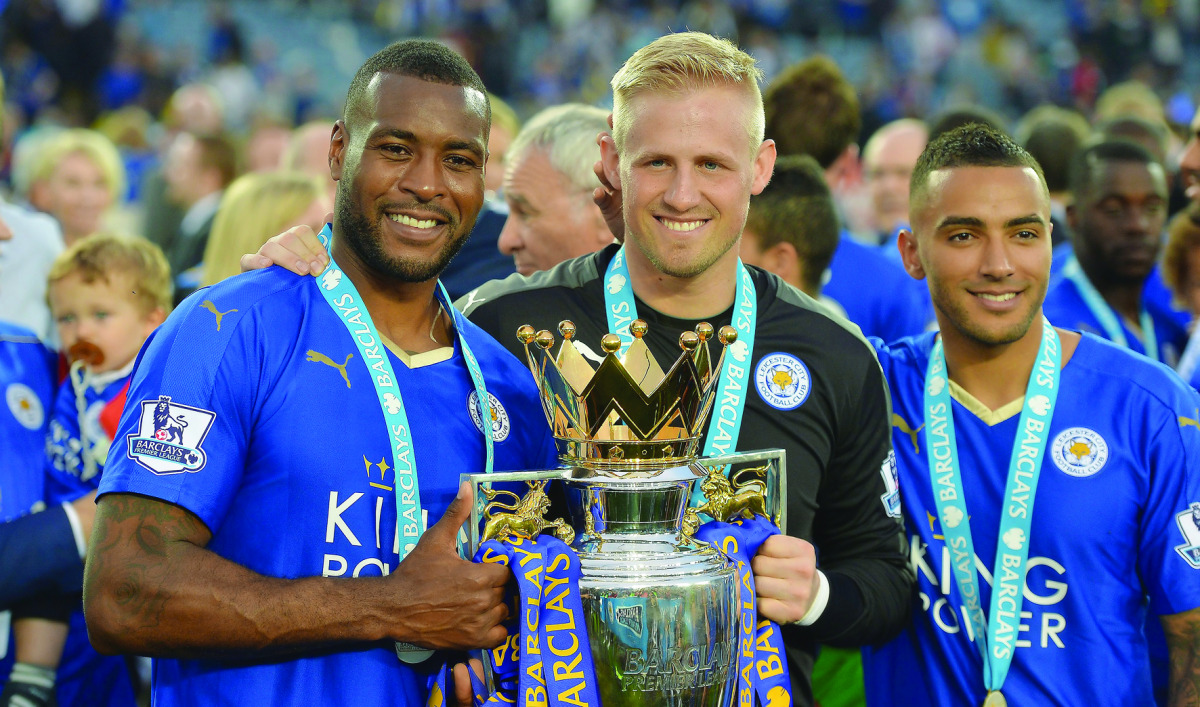 Leicester City’s goalkeeper Kasper Schmeichel (centre) with Wes Morgan (left) and Danny Simpson lift the Premier League trophy at the King Power Stadium in Leicester, Britain, in this May 2016 file photo.