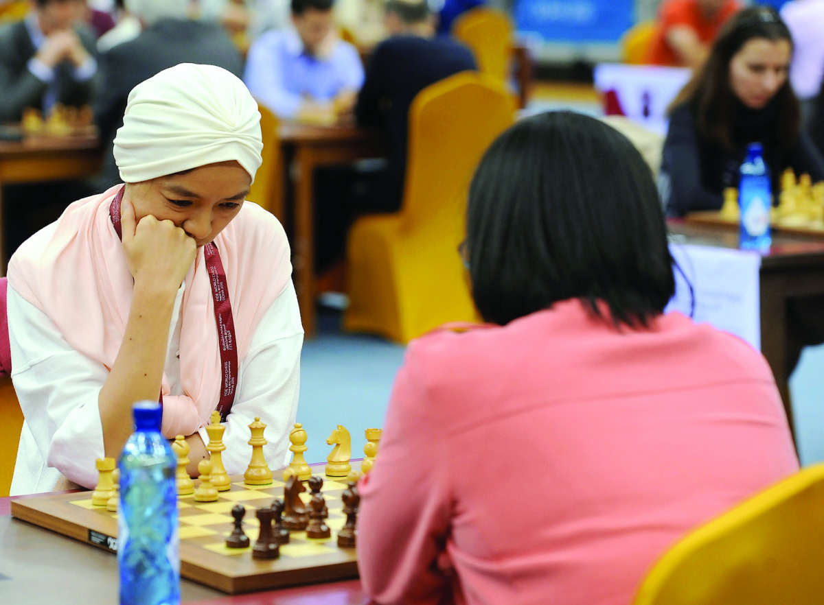 Zu Chen (left)  of Qatar pondering her next move at the Qatar Rapid and Blitz Championships, at the Ali Bin Hamad Attiya Arena, Al Sadd, in Doha yesterday.