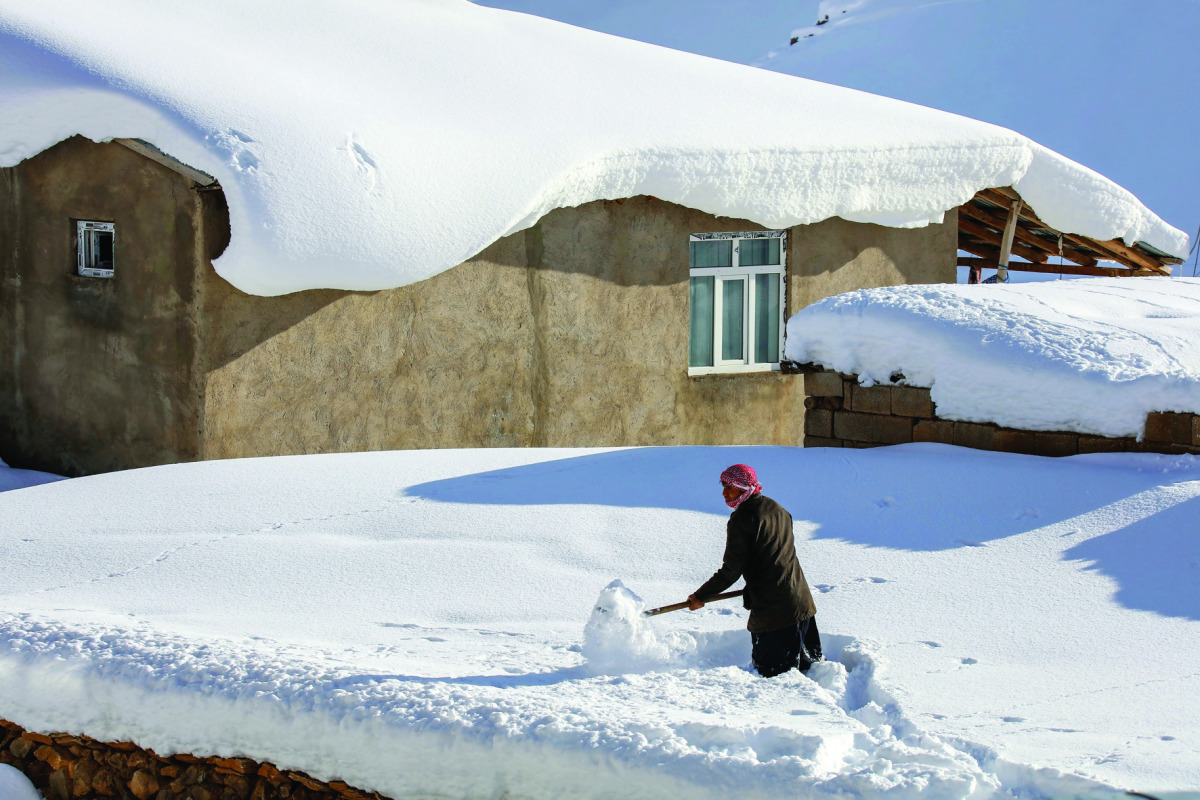 A man shovels away some snow during inclement weather conditions in Van, Turkey on December 27, 2016. Weather affects the everyday lives of people at Yukari Narlica district of Van in Eastern Anatolia Region of Turkey. ( Ali ?hsan Öztürk - Anadolu Agency 
