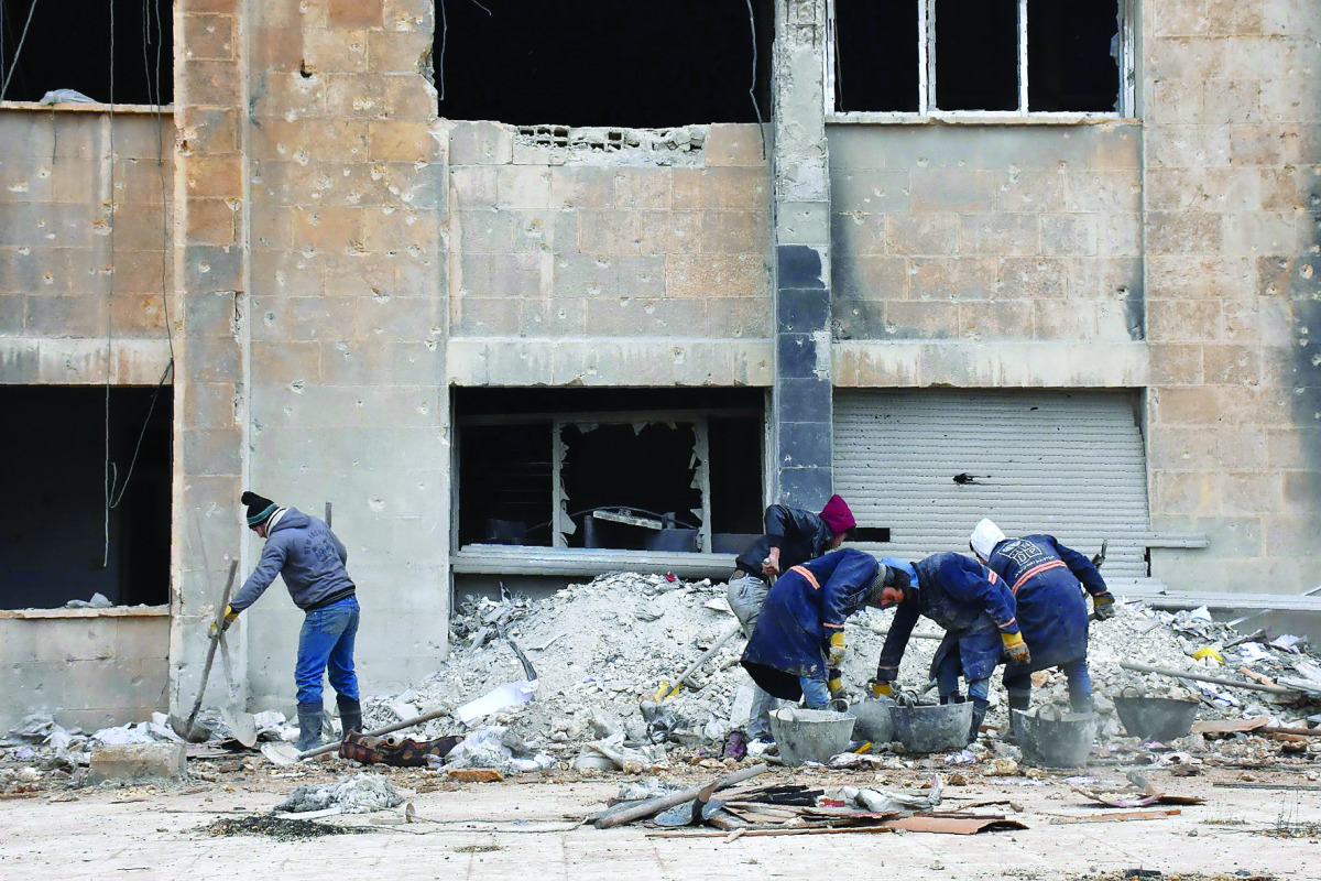 Syrian workers clean up the water station in Aleppo's Suleiman Al Halabi neighbourhood. 