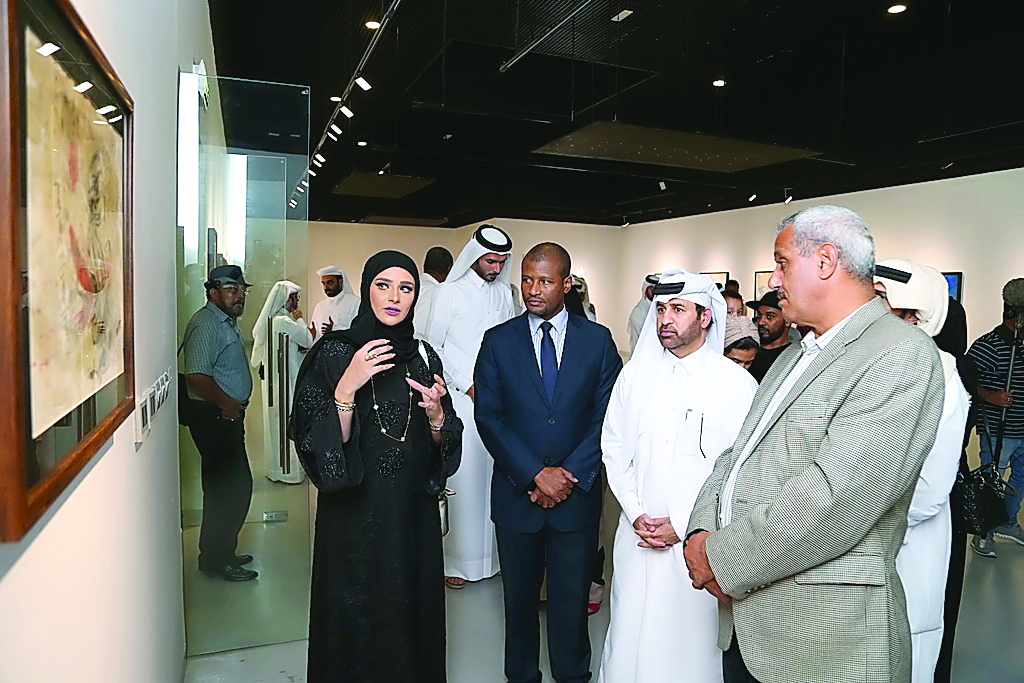 Qatari artist Jameela Al Ansari (left) explains one of her paintings to Katara General Manager Dr Khalid bin Ibrahim Al Sulaiti (second right) and other officials at the opening of 'Salam' exhibition on Tuesday at Katara. 