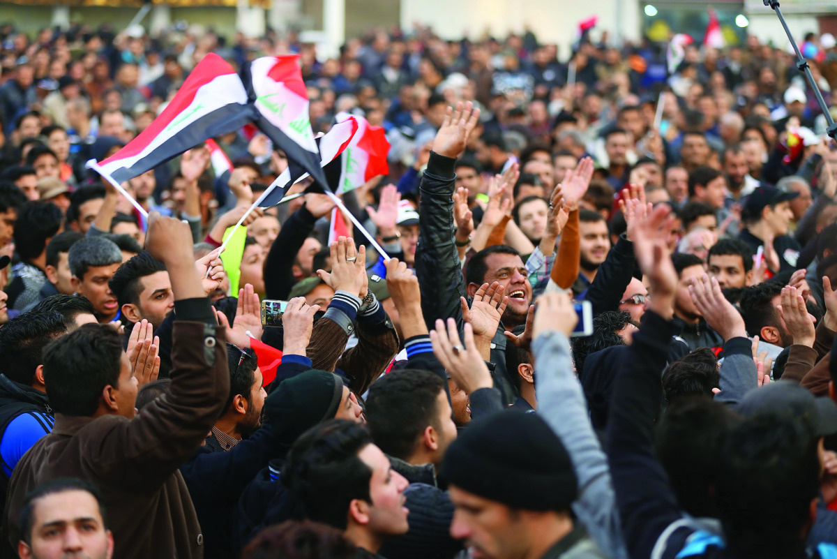 Supporters of  Muqtada Al Sadr chant slogans during a demonstration against corruption and demanding reforms, in Baghdad, Iraq, yesterday.
