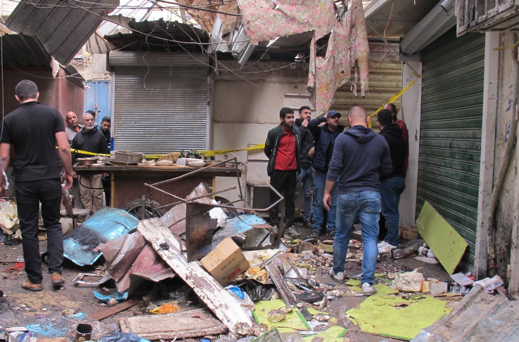BAGHDAD, IRAQ - DECEMBER 31: Iraqis inspect the scene of suicide attacks at a bazaar in Baghdad, Iraq on December 31, 2016. At least 24 people were killed and dozens injured in a twin bombing claimed by Daesh terrorist group in the Iraqi capital Baghdad o