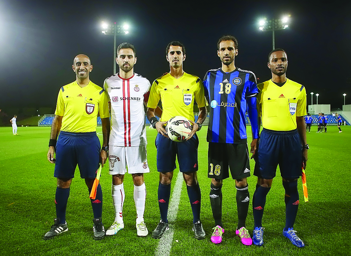 The two captains and referees pose for a photograph prior to the friendly game on Friday.