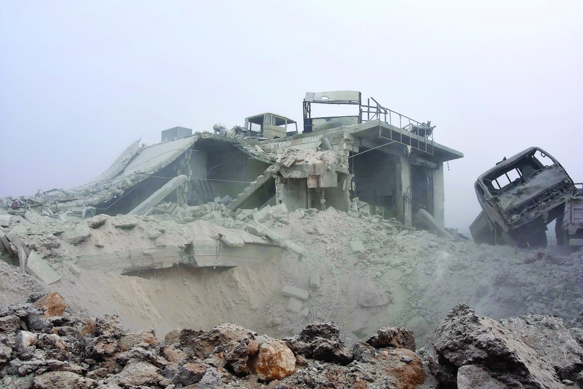 Damaged building and vehicles are seen after regime warplanes attacked with vacuum bomb to Etarib district of Aleppo, Syria, yesterday. 