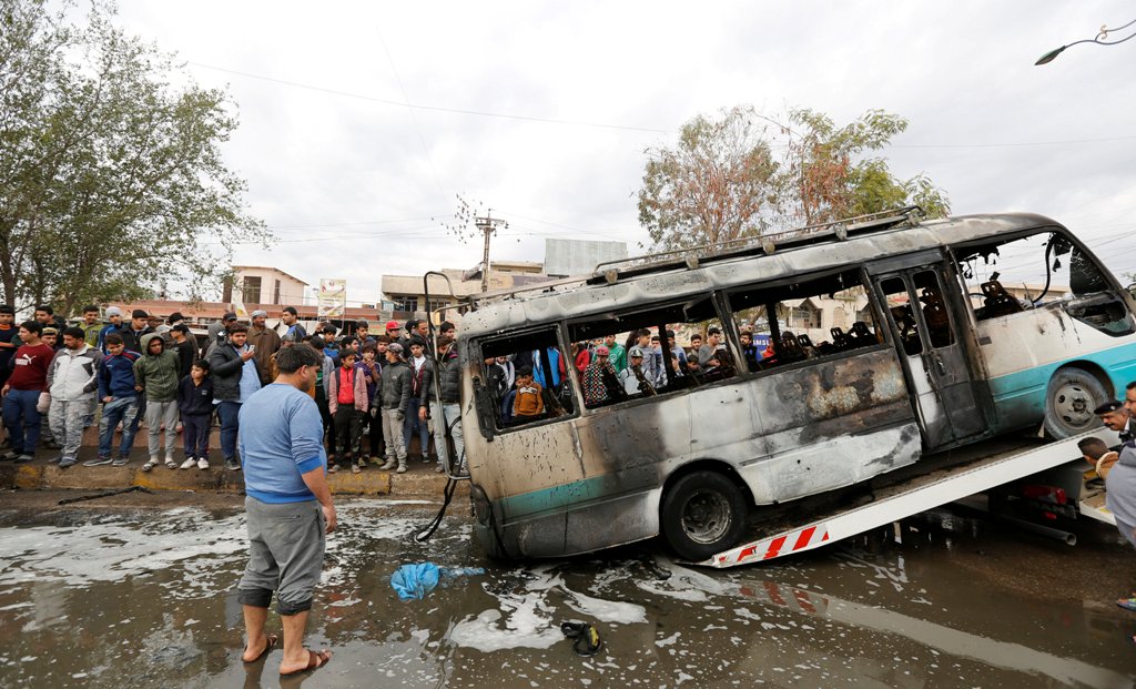 A burned vehicle is removed from the site of car bomb attack in a busy square at Baghdad's sprawling Sadr City district, in Iraq January 2, 2017. REUTERS/Ahmed Saad