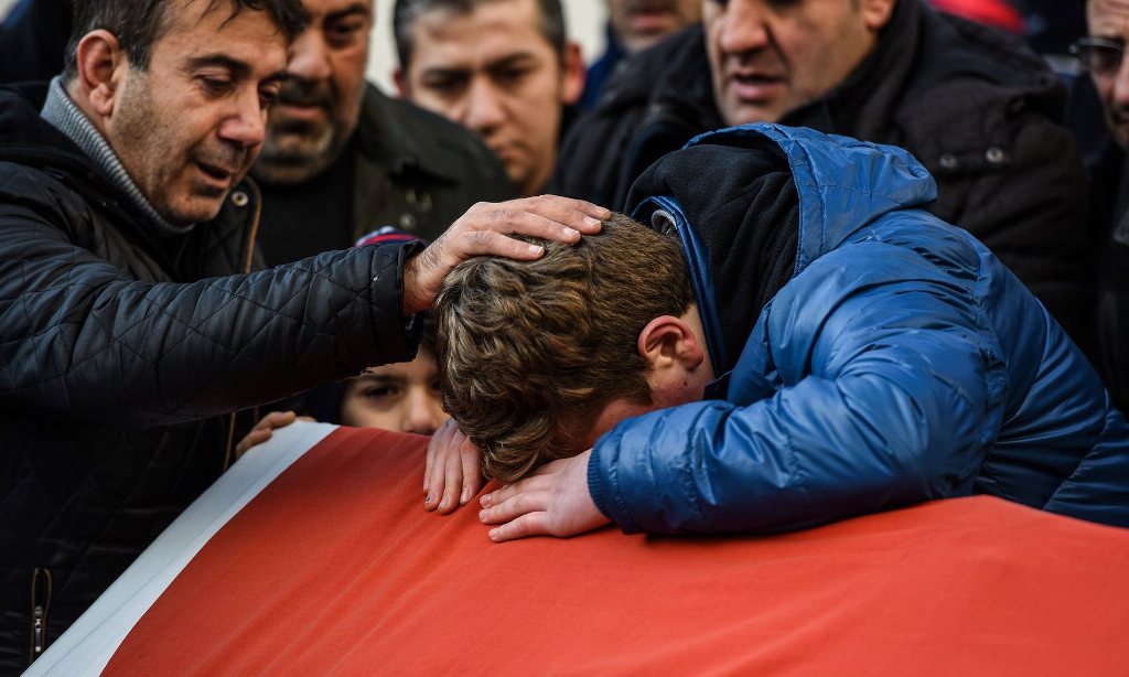 Relatives of Ayhan Arik, one of the victims of the Reina nightclub attack, mourn during his funeral. Photograph: Ozan Kose/AFP.