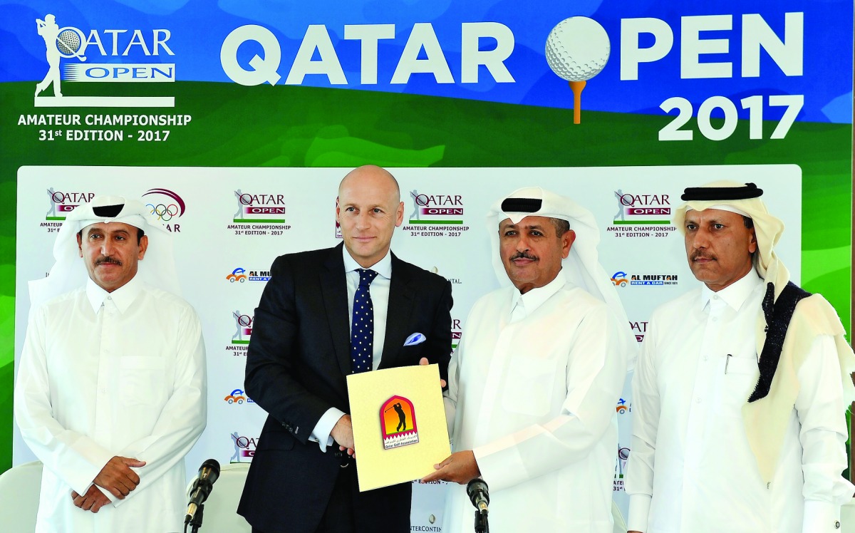 Andreas Pfister (second left), General Manager of InterContinental Doha and Fahad Nasser Al Naimi, General Secretary of Qatar Golf Association (QGA) exchange documents after signing an agreement at Doha Golf Club yesterday. Mohammed Faisal Al Naimi, Execu