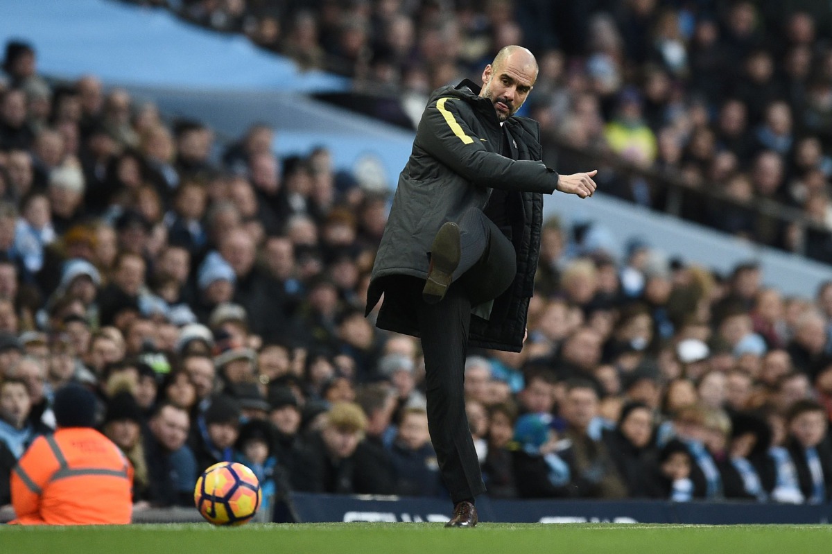 Manchester City's Spanish manager Pep Guardiola kicks the ball back onto the pitch during the English Premier League football match between Manchester City and Burnley at the Etihad Stadium in Manchester, north west England, on January 2, 2017. (AFP / Oli