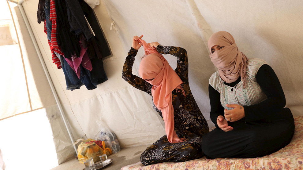 FILE PHOTO: Yazidi sisters, who escaped from captivity by Islamic State (IS) militants, sit in a tent at Sharya refugee camp on the outskirts of Duhok province, Iraq, July 3, 2015. Reuters
