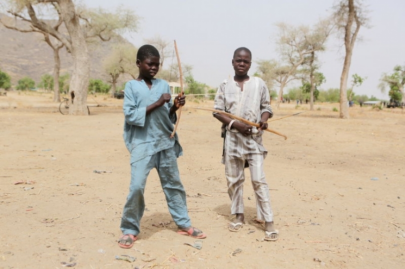 Boys hold bows and arrows in Kerawa, Cameroon, March 16, 2016. REUTERS/Joe Penney