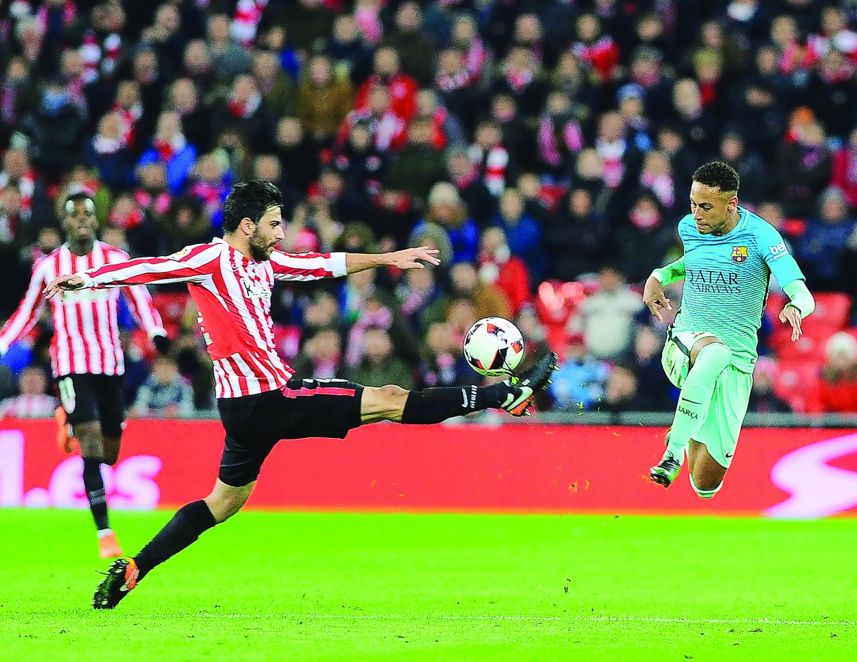 Athletic Bilbao's Eneko Boveda (left) vies for the ball possession with Barcelona's Neymar during their Spanish Copa del Rey match at the San Mames Stadium in Bilbao, Spain on Wednesday.