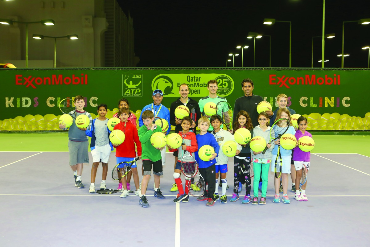 World no. 1 men’s doubles team Jamie Murray and Bruno Soares pose for a photograph with children from the ExxonMobil Qatar community during a coaching clinic in Doha.
