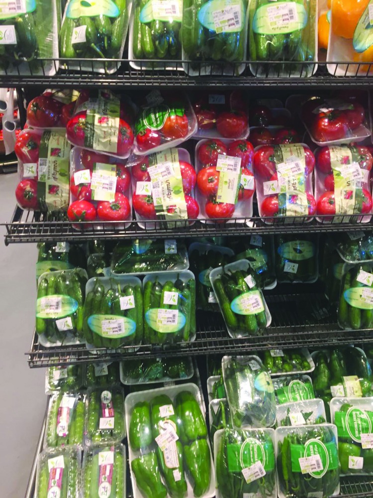 Fresh vegetables from local farms displayed on the shelves at an Al Meera outlet.