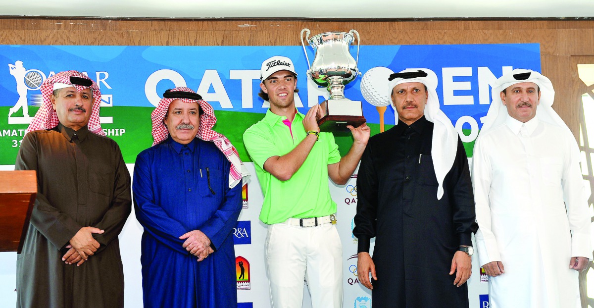 Netherlands'  Pierre Verlaar Jr poses for a photograph with Qatar Open Amateur Golf Championship trophy in the presence of Hassan Al Naimi, (second left) President of Qatar Golf Association (QGA), Fahad Al Naimi, (left) QGA General Secretary, Mohamed Al M