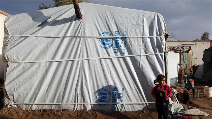 An Internally Displaced Syrian girl, fled from East Ghouta region is seen outside of a tent at a makeshift camp, relatively safer than their home neighborhoods in Damascus, Syria on January 10, 2017. ( Tarik al Masri - Anadolu Agency ).