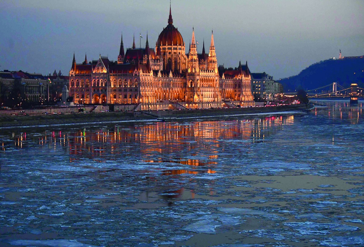 Ice floes float in the water of the River Danube nearby the parliament building of Budapest, Hungary, yesterday. A cold snap gripping Europe has killed more than 30 people in recent days, left thousands of travellers stranded in snow-covered Turkey and br